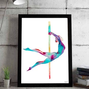 May include: A framed watercolor print of a person pole dancing. The figure is rendered in vibrant shades of teal, pink, and purple, with a golden pole. The artwork is set against a white background, framed in black, and placed on a concrete surface.