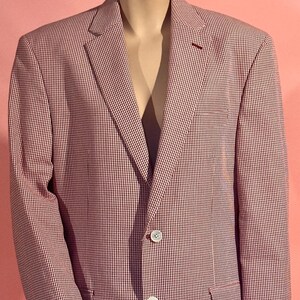 May include: A red and white gingham blazer with a three-button closure. The blazer has a classic fit and a slightly oversized silhouette.