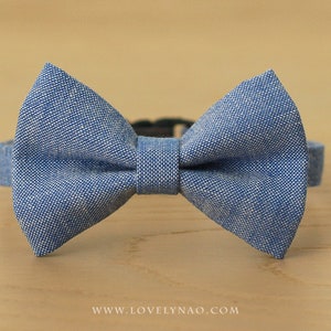 May include: A light blue bow tie made of a textured fabric.