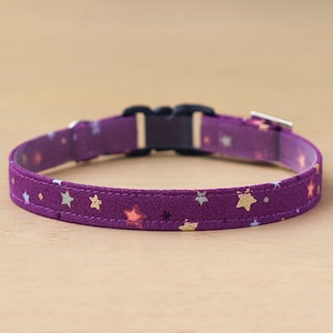 May include: A purple cat collar with a star pattern and a black plastic buckle.