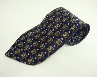 May include: Rolled navy blue tie with a repeating pattern of golf clubs, golf balls, and squares in shades of gray, brown, and red. The tie is made of a smooth fabric and is suitable for formal or business attire.