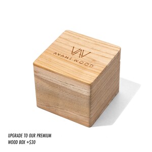 May include: A wooden box with the text "AVANT WOOD" engraved on the top. The box is made of light wood and has a natural finish.