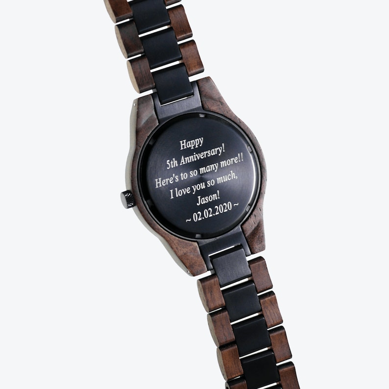 May include: A brown and black wooden watch with a black face. The watch face has a personalized message that reads "Happy 5th Anniversary! Here's to so many more!! I love you so much, Jason! ~02.02.2020~"