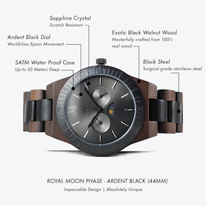 May include: A black and brown wooden wristwatch with a black dial and moon phase complication. The watch has a sapphire crystal, a 5 ATM water-resistant case, and a black steel surgical grade stainless steel band. The watch face features the text "AVANT WOOD" and "VW". The watch is labeled "ROYAL MOON PHASE - ARDENT BLACK (44MM)" and "Impeccable Design | Absolutely Unique".