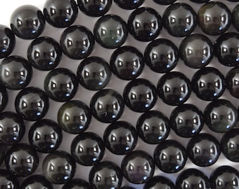 May include: A strand of black obsidian beads, each bead is round and smooth with a high gloss finish.