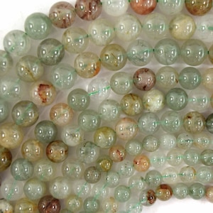 May include: A strand of round, translucent green and brown gemstone beads. The beads have a speckled, cloudy appearance.