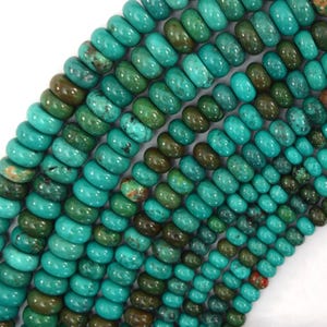 May include: A strand of turquoise beads, each bead is a light to dark green color with brown and black marbling. The beads are round and have a smooth, polished finish.