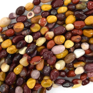 May include: A strand of mixed gemstone beads in shades of red, brown, yellow, and white. The beads are smooth and polished, with a variety of patterns and textures.