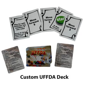 May include: A custom UFFDA game deck with playing cards featuring instructions for the game. The cards are silver with black text and images. The game is played with marbles and the cards instruct players to move forward, knock off marbles, and pay an ante.