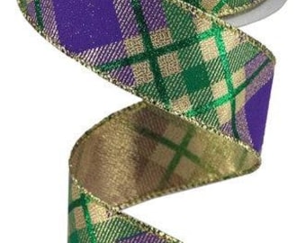 May include: A spool of decorative ribbon with a plaid pattern in purple, green, and gold. The ribbon is spiraling downward, showcasing the pattern and the gold trim on the edges. The ribbon is on a white spool.