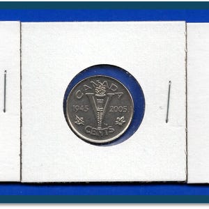 May include: Three Canadian nickel coins from 1945 and 2005, presented in individual white coin holders. The coins display the word "CANADA" and the denomination "CENTS". The holders are arranged on a blue background.