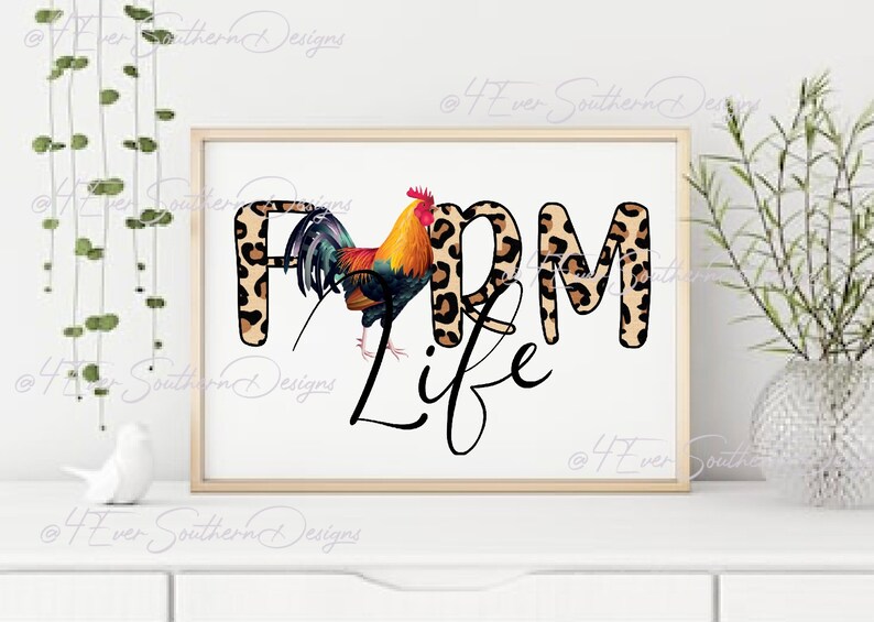 May include: Framed artwork with the words "FARM LIFE" in a mix of leopard print and black script. A colorful rooster stands next to the word "FARM". The artwork is displayed on a white surface.