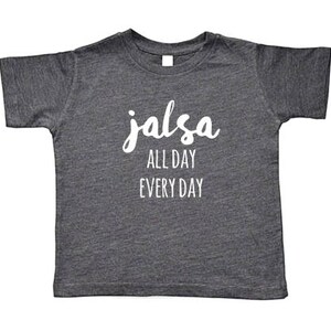 May include: A dark gray t-shirt with the text "salsa all day every day" in white lettering.