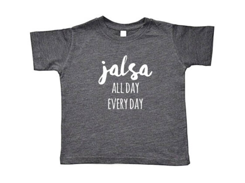 May include: A dark gray t-shirt with the text "salsa all day every day" in white lettering.