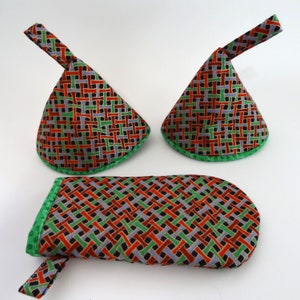 May include: Three-piece set of fabric items with a woven pattern in red, green, black, and gray. The set includes two cone-shaped items with handles and a rectangular case. All pieces have a green border.