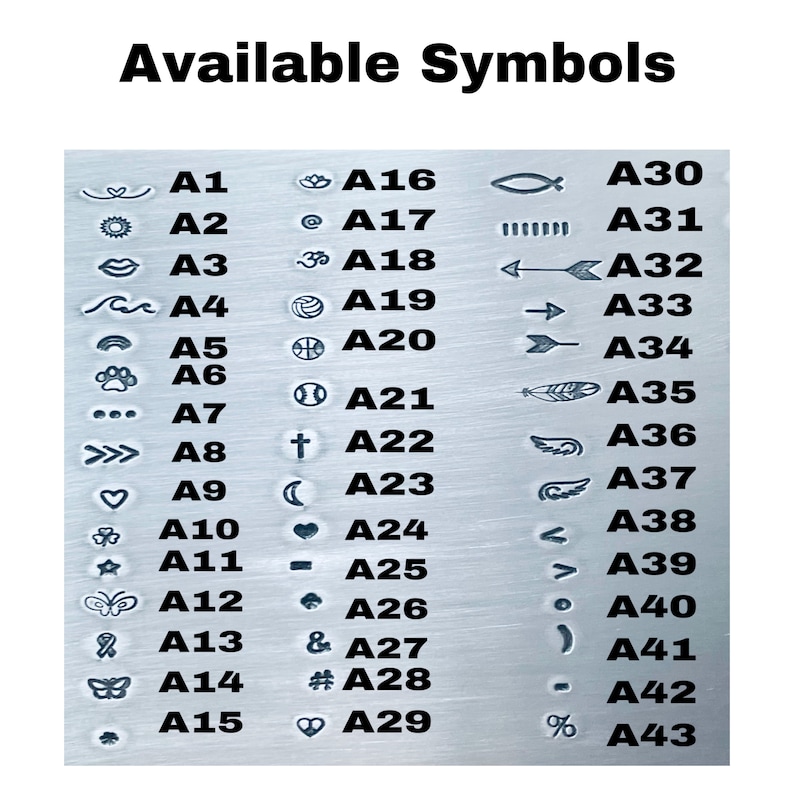 May include: A chart of available symbols for customization. The symbols are organized in two columns with a letter and number code next to each symbol. The symbols include a heart, a sun, a wave, a paw print, a cross, a crescent moon, a star, a butterfly, a feather, an arrow, a fish, a peace sign, a music note, a number sign, and more.