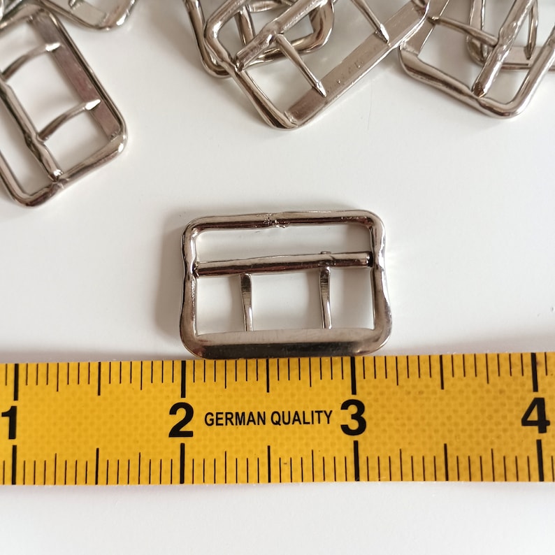 the photo shows the fastener  photographed next to a tape measure