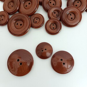 the photo shows the reverse of buttons and the style of attachment, two holes