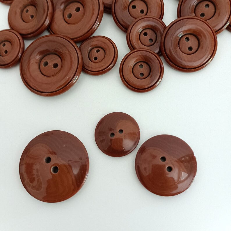the photo shows the reverse of buttons and the style of attachment, two holes