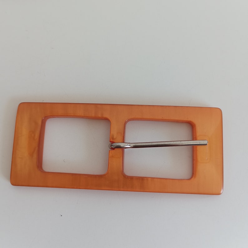 the photo shows orange plastic buckle