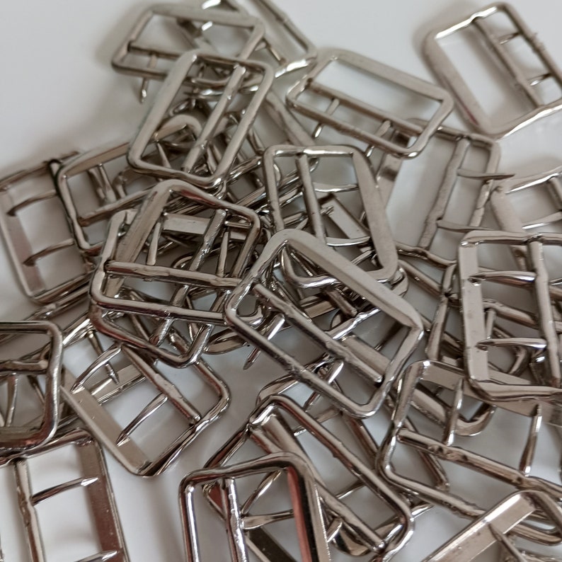 the photo shows vest silver metal buckles fasteners