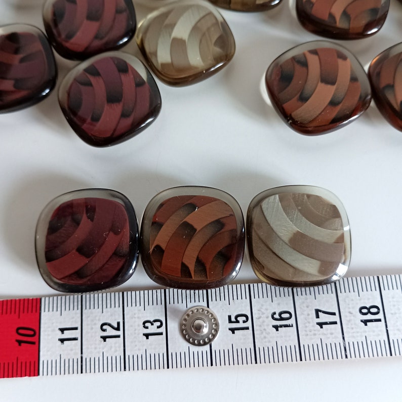 the photo shows the buttons next to a tape measure
buttons size: 25mm