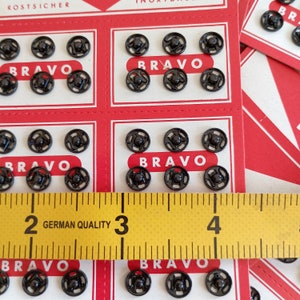 the snaps are photographed next to a tape measure
snap size: 0.27 inches