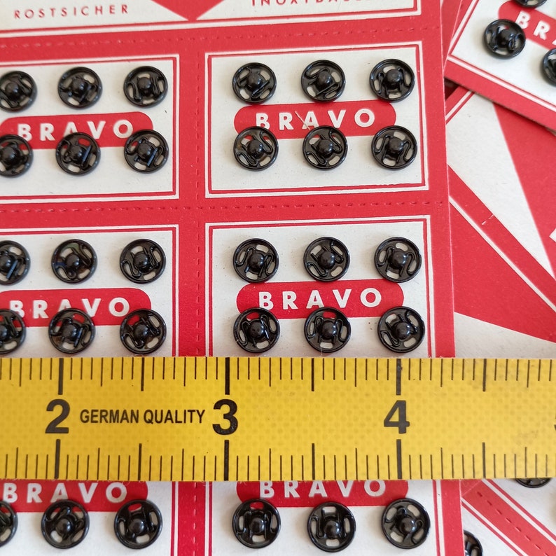 the snaps are photographed next to a tape measure
snap size: 0.27 inches