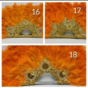 May include: Orange feather fans with gold and silver embellishments. The fans feature intricate gold lace designs and sparkling accents. The feathers are a vibrant orange, creating a striking contrast with the metallic details.