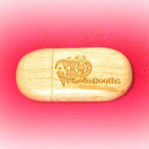 May include: A wooden USB drive with the text "PhotoBooths" and a logo of a star and a circle engraved on it.