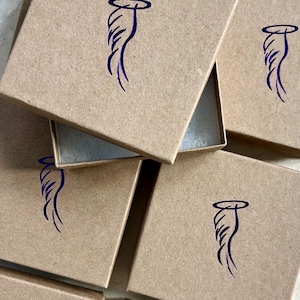 May include: Multiple brown cardboard boxes with a blue angel wing design on the top of each box.