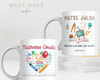 May include: Two white ceramic mugs featuring school-themed graphics on lined paper backgrounds. One mug displays 'Maître Julien' with school supplies, the other 'Maîtresse Coralie' with a heart-shaped arrangement of stationery and the text 'merci de m'avoir appris tant de choses'.