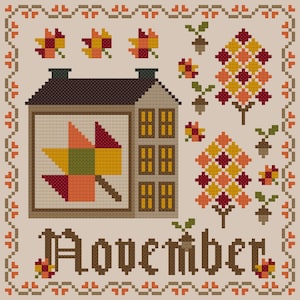 May include: A cross-stitch pattern featuring a house with a quilt block depicting a leaf, two trees with a quilt block design, and the word "November". The design is in shades of brown, orange, yellow, and red.