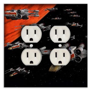 May include: A black and red wall plate with four white electrical outlets. The background image features a space scene with multiple X-Wing starfighters flying through a star field.