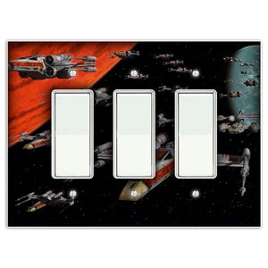 May include: A triple light switch cover with a Star Wars X-Wing fighter space battle scene. The cover features a red and orange planet in the background and a black and white starry sky with multiple X-Wing fighters flying in formation.