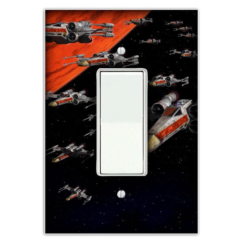May include: A light switch cover featuring a black and red space scene with multiple X-Wing starfighters flying in formation. The scene is set against a backdrop of stars and a red planet.