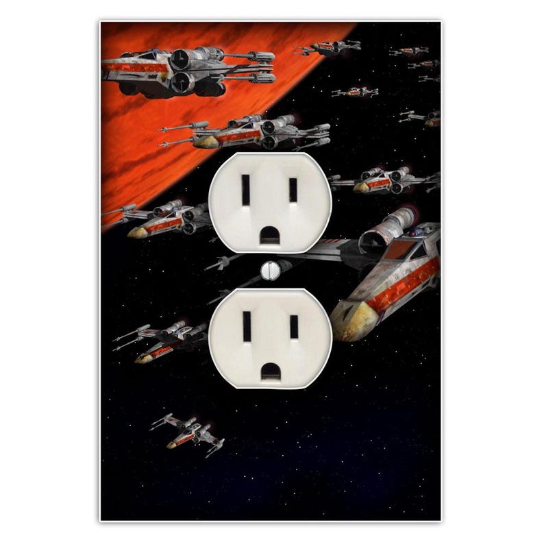 May include: A black and red wall plate with two standard electrical outlets. The plate features a design of X-Wing starfighters from the Star Wars franchise flying through space.