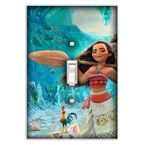 May include: A light switch cover featuring Moana from the Disney movie Moana. Moana is standing in the ocean with a paddle in her hand. She is wearing a red and white top and a white skirt. A rooster and a pig are in the foreground.