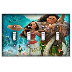 May include: A light blue, green, and white light switch cover with a colorful image of Moana and Maui from the Disney movie Moana. Moana is holding a wooden paddle and Maui is holding a fish hook. The background is a blue ocean with waves.
