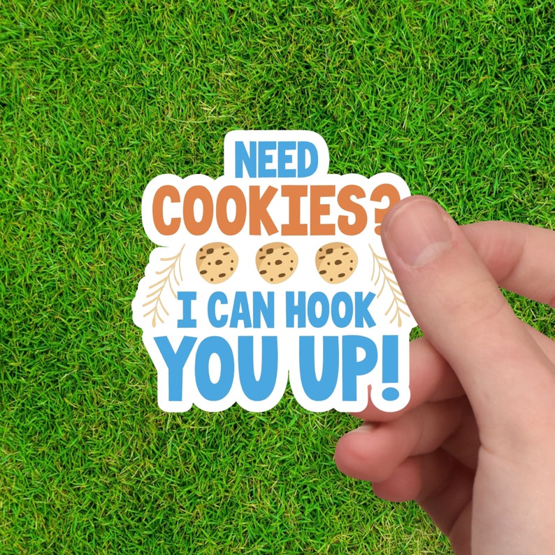May include: A blue and orange sticker with the text "NEED COOKIES? I CAN HOOK YOU UP!" and three cartoon cookies.