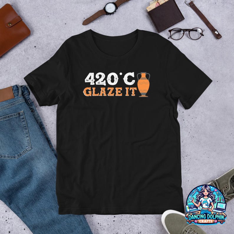 May include: Black t-shirt with white text that reads "420&deg;C Glaze It" and a graphic of an orange ceramic vase.