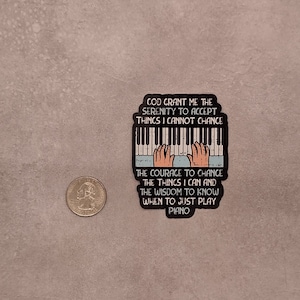 May include: A sticker with a piano keyboard and hands playing. The text reads "God grant me the serenity to accept things I cannot change. The courage to change the things I can and the wisdom to know when to just play piano."