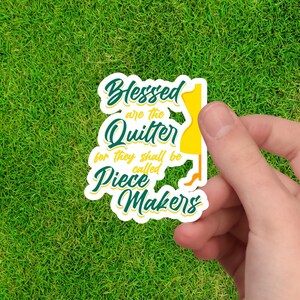 May include: A white sticker with green and yellow text that reads "Blessed are the Quitter for they shall be called Piece Makers". A yellow silhouette of a dress form is to the right of the text.