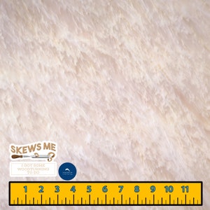 May include: A close-up of a light beige wood grain surface with a ruler and a sticker that says "Skews Me I got some woodturning to do".