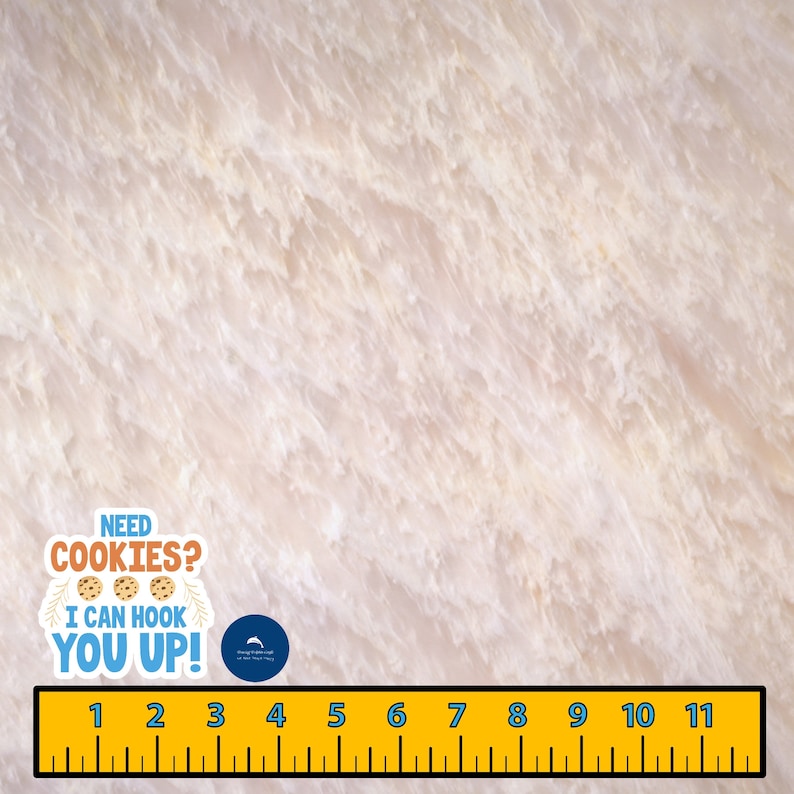 May include: A white marble surface with a yellow ruler and a blue and white sticker that says "NEED COOKIES? I CAN HOOK YOU UP!" with three cookie images.