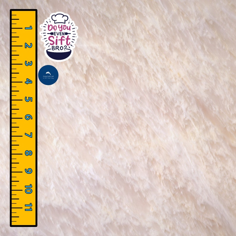 May include: A close-up of a white, textured surface with a ruler marked in inches from 1 to 11.  Two stickers are on the surface. One sticker is a white circle with a blue outline and a white arrow pointing to the right. The other sticker is white with a pink outline and features a chef's hat and the text "Do you even Sift BRO?"