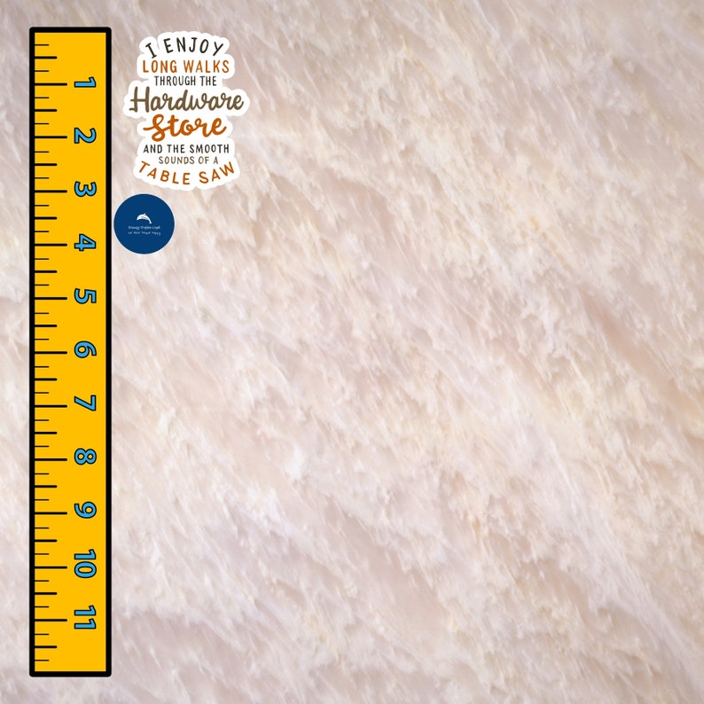 May include: A yellow ruler with black markings from 1 to 11. The ruler is next to a white background with a blue circle sticker that says "I enjoy long walks through the hardware store and the smooth sounds of a table saw".