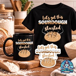 May include: A black t-shirt, a black ceramic mug, and a sticker, each featuring the text "Let's get this SOURDOUGH started" in white and tan lettering above a graphic illustration of a round loaf of sourdough bread with steam rising from it.