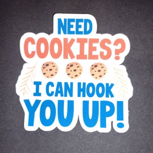 May include: White sticker with blue, red, and brown text that reads "Need Cookies? I can hook you up!" with three brown chocolate chip cookies in the middle.