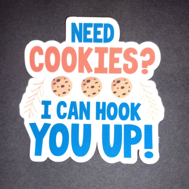 May include: White sticker with blue, red, and brown text that reads "Need Cookies? I can hook you up!" with three brown chocolate chip cookies in the middle.